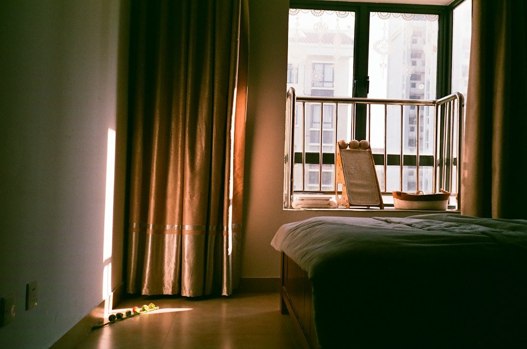 Soft morning light through bedroom curtains