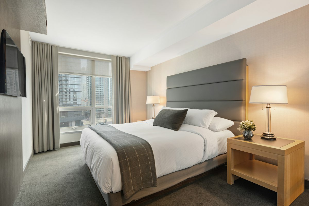 Clean modern bedroom with mid-range memory foam mattress and neutral bedding for better sleep
