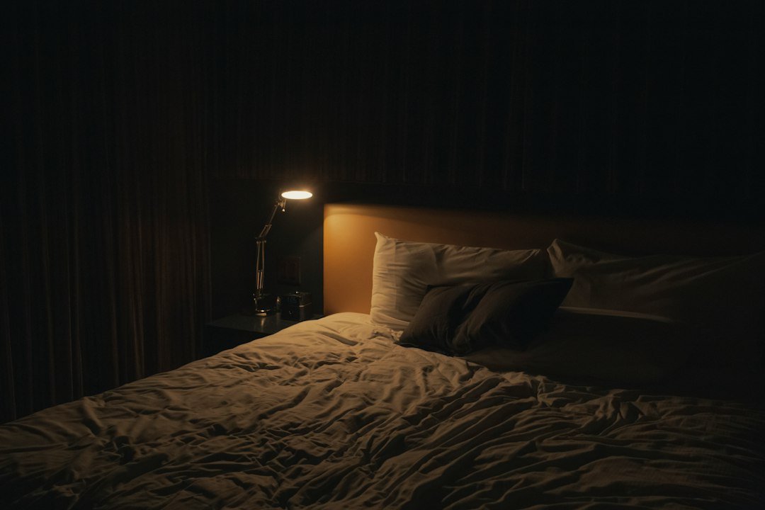 Cozy bedroom with soft lamp light near the bed