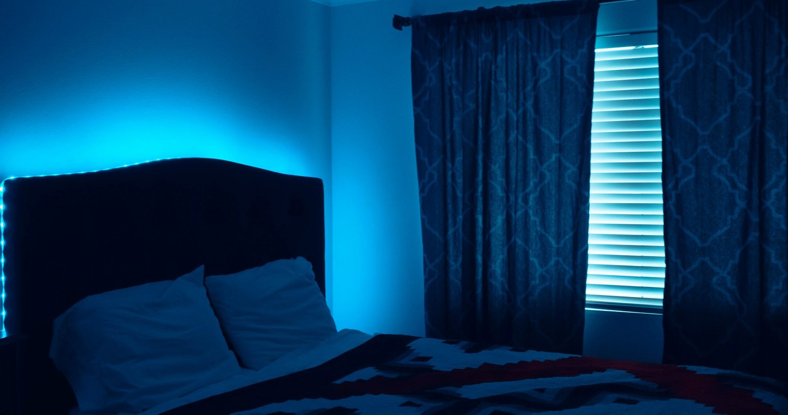 Bedroom with blackout curtains fully closed creating a dark sleep environment