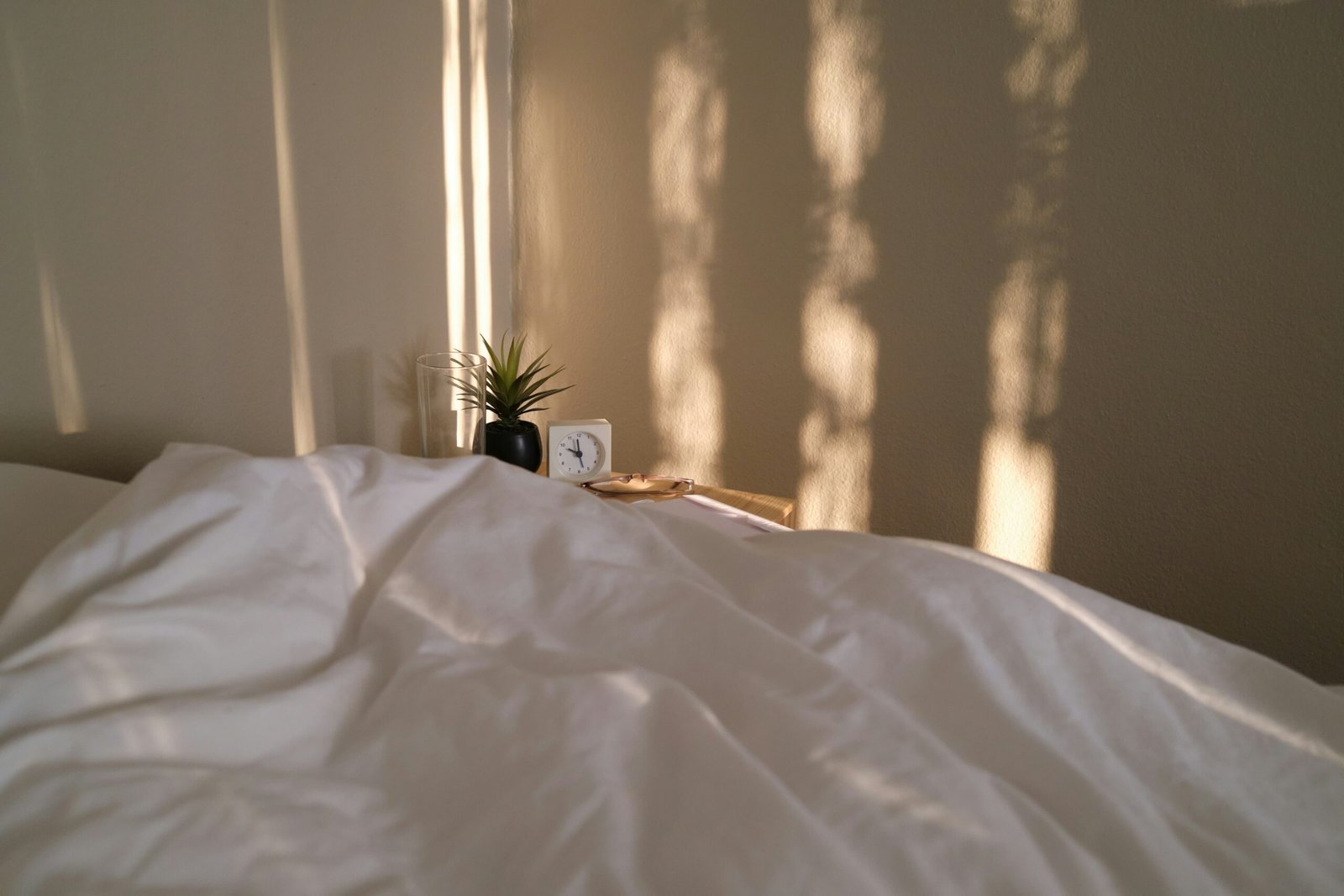 Comfortable bedroom setup with mattress and soft evening lighting for better sleep