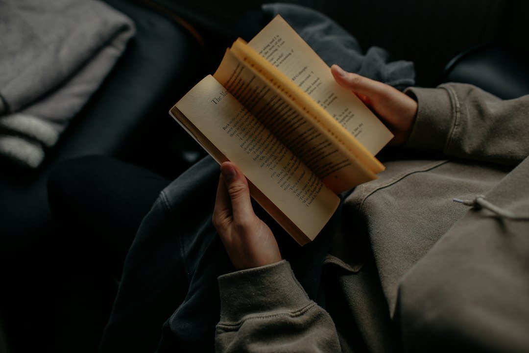 Person reading a book in a calm setting