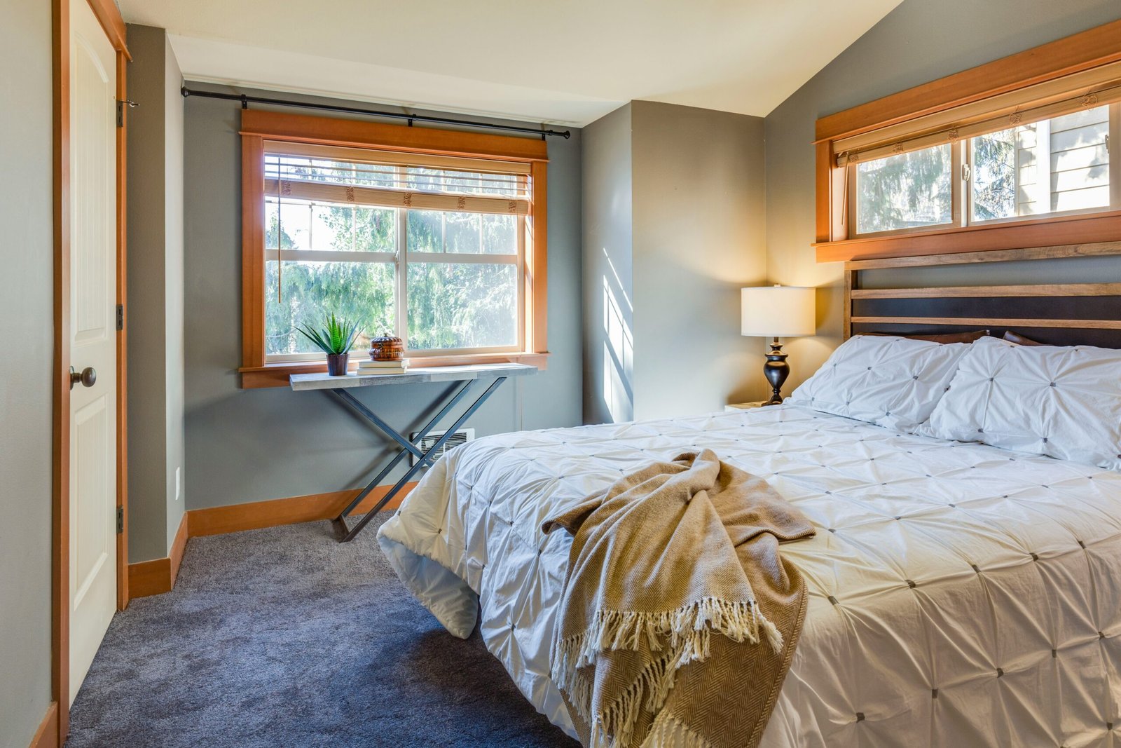 Clean white bedding on a bed in soft light, representing a cool sleep setup for weighted blankets